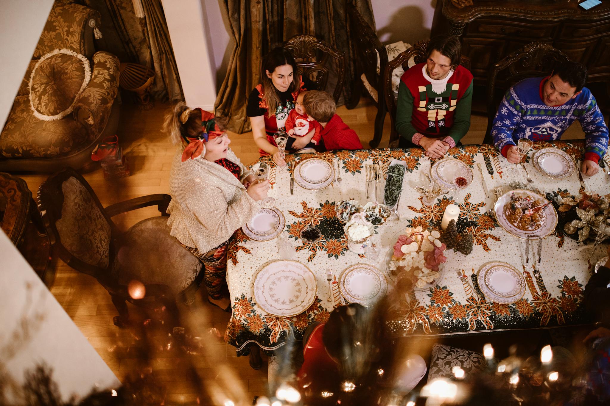 A joyful family enjoying a festive meal together at a beautifully decorated holiday table.